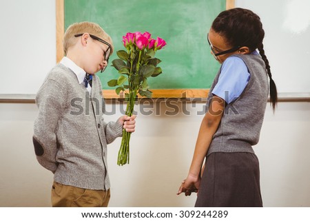 Student giving flowers to another student at the elementary school