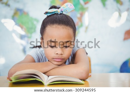 Student reading from a school book at the elementary school