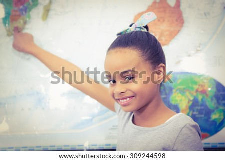 Student pointing to a map of the world at the elementary school