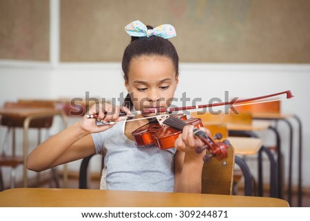 Student using a flute in class at the elementary school