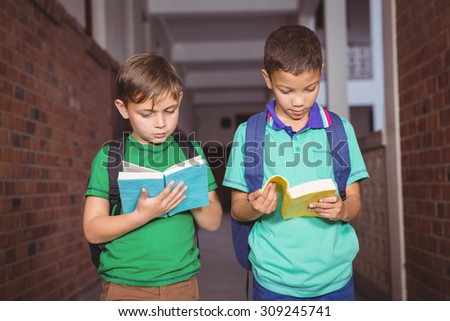 Students reading books together on the elementary school grounds