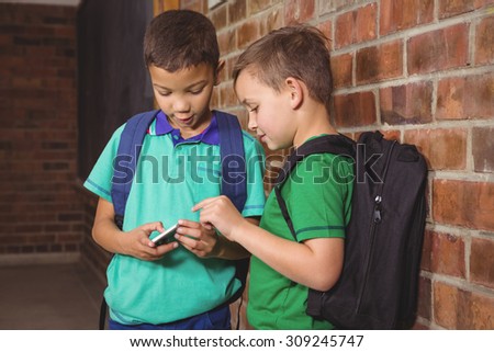Student showing off their new mobile phone on the elementary school grounds
