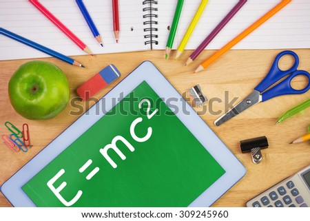 Theory of relativity against students table with school supplies