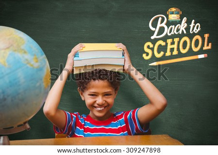 Cute pupil with books against green chalkboard