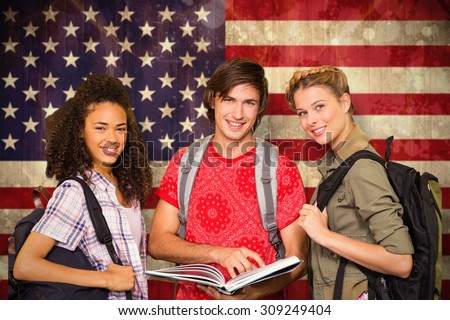 College students reading book in library against usa flag in grunge effect