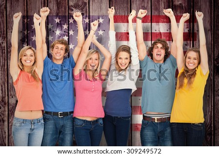 Smiling people raising hands up in the air against composite image of usa national flag