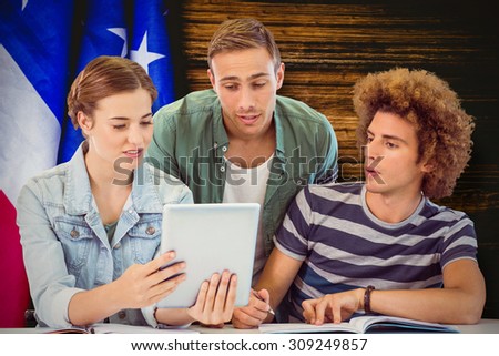 Fashion students using tablet against usa flag on table