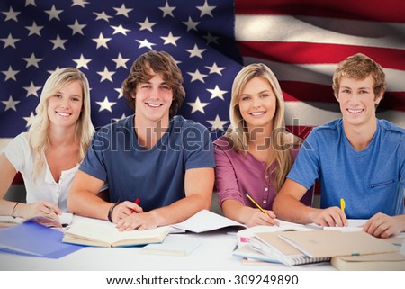 Four students looking at the camera against digitally generated american national flag