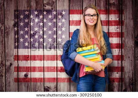 Pretty student in the library against composite image of usa national flag