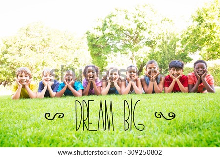 The word dream big against happy friends in the park