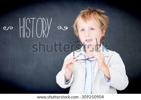The word history against boy dressed as teacher in front of black board