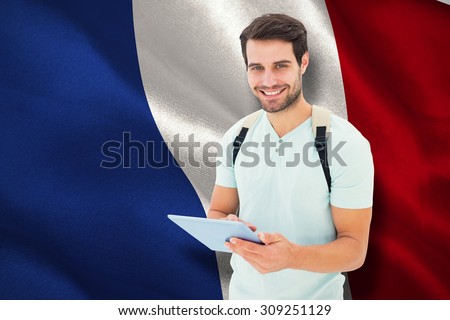 Student using tablet pc against digitally generated french national flag