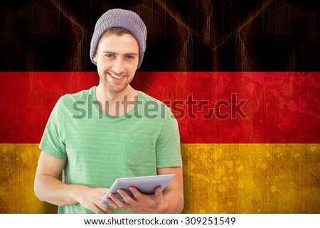 Student using tablet against germany flag in grunge effect