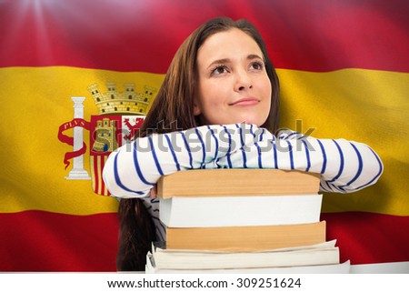 Students studying against digitally generated spanish national flag
