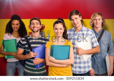 Students holding folders in college against spain national flag