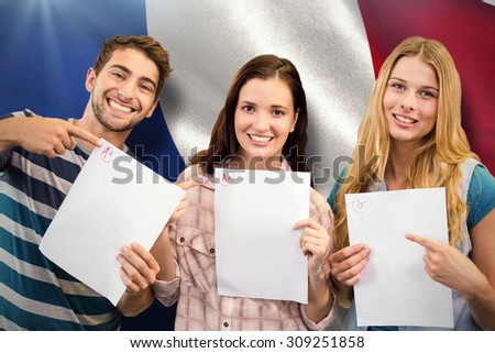 Smiling students showing their exams against digitally generated french national flag