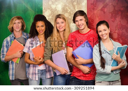 College students holding books in library against italy flag in grunge effect