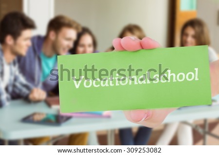 The word vocational school and hand showing card against smiling friends students using laptop
