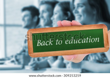The word back to education and hand showing chalkboard against smiling friends students talking and writing