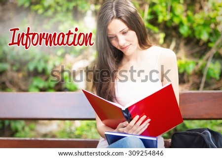 The word information against pretty student studying outside on campus