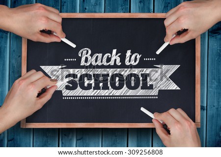 Multiple hands writing with chalk against blackboard with copy space on wooden board