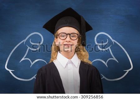 Cute pupil in graduation robe against blue chalkboard