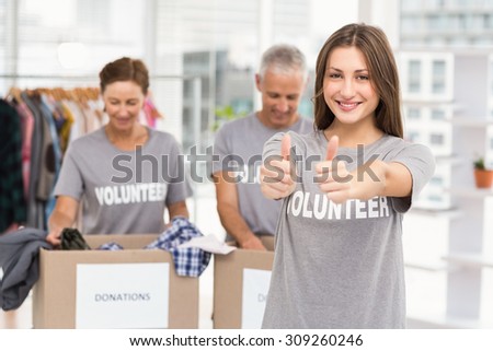 Portrait of smiling female volunteer doing thumbs up in the office