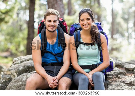 Young happy joggers looking at the camera in the nature