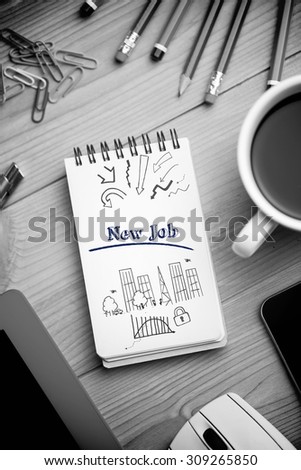 The word new job and business and cityscape against notepad on desk