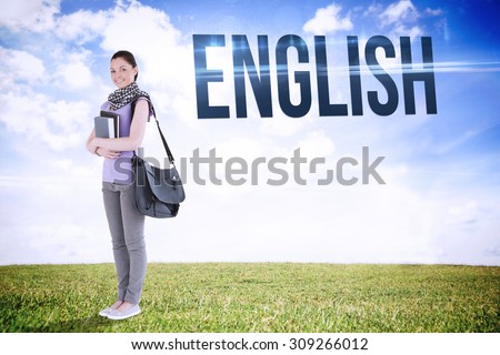 The word english and attractive student holding books and her bag while standing against serene landscape