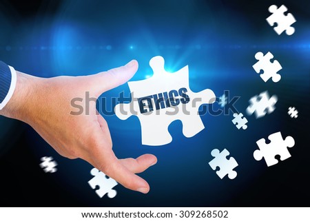 The word ethics and businessman pointing with his finger against blue background with vignette