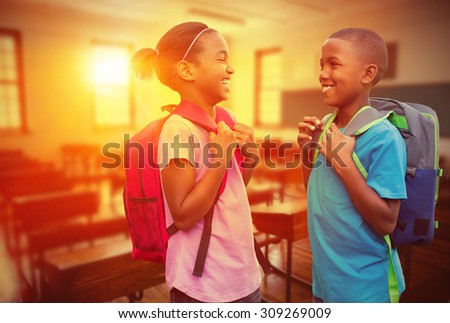 Smiling pupils against empty classroom