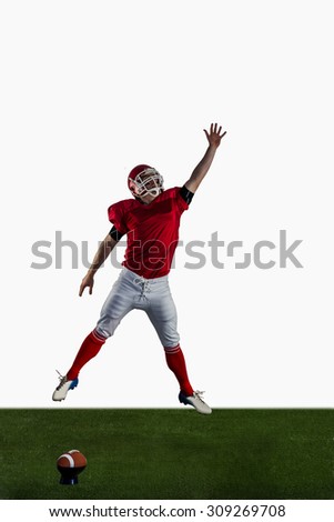 American football player trying to catch football on american football field