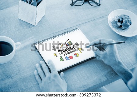 Man writing notes on notebook against strategy and development doodle