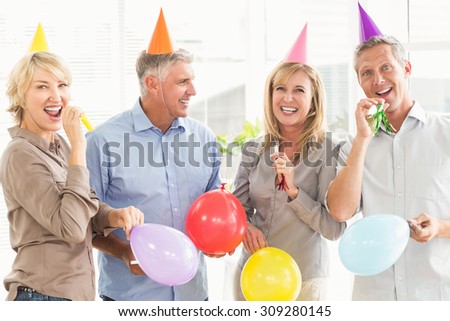 Portrait of happy casual business people celebrating birthday in the office