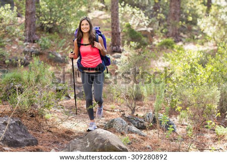 Young happy jogger hiking in the nature