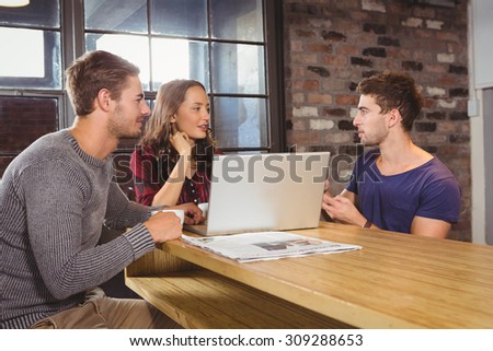 Friends talking and having coffee together at coffee shop