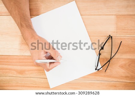 Hand writing on paper on wooden desk
