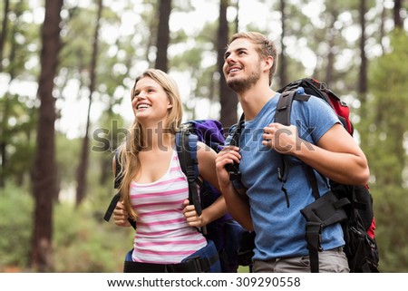 Young happy hiker couple looking in the distance in the nature