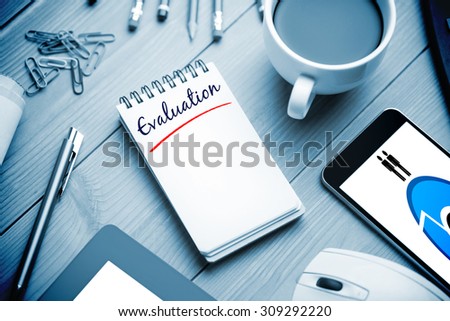 The word evaluation and coumpting against notepad on desk