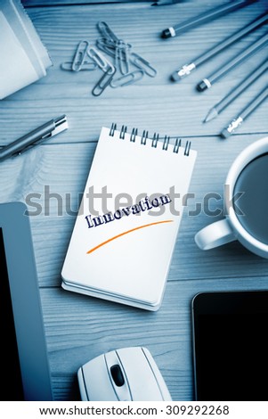 The word innovation against notepad on desk