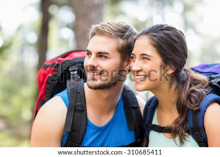 Young happy joggers looking at something in the distance in the nature