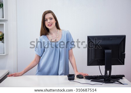 Shop worker standing by the till in fashion boutique