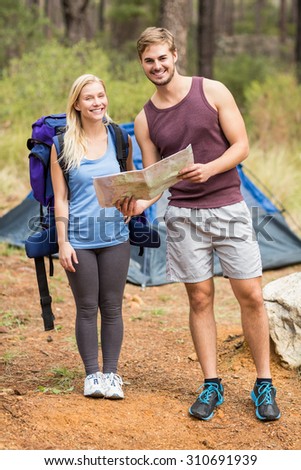 Young happy joggers looking at camera in the nature