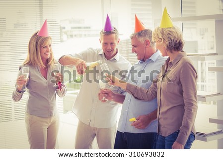 Casual business people toasting and celebrating birthday in the office