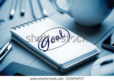 The word goal against notepad on desk
