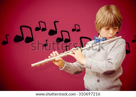 Cute pupil playing flute against red background
