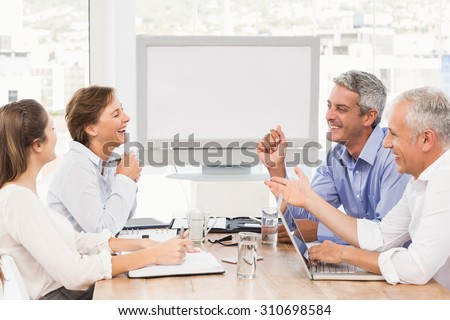 Laughing business people having a meeting in the office