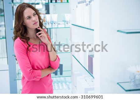 Pretty woman shopping for cosmetics at the pharmacy