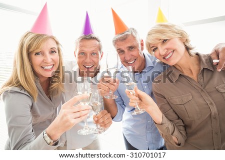Portrait of casual business people making birthday toasts in the office